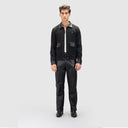 Man wearing black casual jacket for men with leather details on collar, cuffs and patch pockets, matched with leather pants