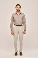 Man wearing gray pleat shirt with fine front pleats, full sleeves and slim fit, paired with light trousers and black belt.