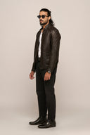 Man wearing black lamb nappa leather jacket, featuring quilted detail, pockets, full sleeves, regular fit, paired with jeans.