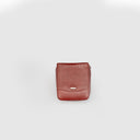 A rust red compact gadget organizer (4.5*5*2.25 inches) to store gadgets, chargers, and cables while on the go