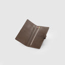 Brown travel organizer wallet in leather with zip section, passport slots, and boarding pass pocket, plain background