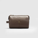 Small brown men’s grooming kit bag in genuine leather with single pocket design, gold-tone hardware, and side strap
