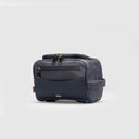 Side view navy blue travel pouch in size large with textured leather, logo plate, and zippered compartments, plain background