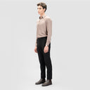 Side view of man in light brown slim-fit lyocell shirt with full sleeves and button loops, paired with black pants and shoes.