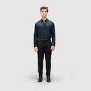 Man in slim-fit navy blue lyocell shirt with full sleeves and button loops, paired with black pants and shoes.