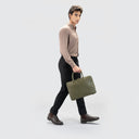 Man side view wearing sleek light brown shirt for men with button loops and full sleeves, paired with black pants and bag.