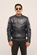 Man wearing navy blue soft leather jacket, full sleeves, flap pockets, regular fit, quilt detail, worn with black pants.