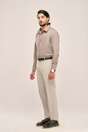 Man wearing tailored gray pleat shirt side view featuring full sleeves in a slim fit, paired with light trousers.