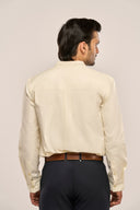 Back view close-up of man in yellow mandarin collar shirt featuring loop-and pleat yoke and full sleeves.