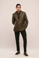 Man wearing mens designer blazer jacket, dark olive nappa leather, shoulder pads, patch pockets, worn with black pants