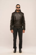Man wearing black lamb nappa leather jacket, full sleeves, snap-button collar, quilted detail, and flap pockets, black jeans.
