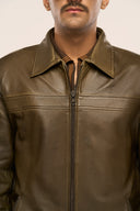 Close-up of man wearing structured dark olive leather jacket for men, featuring front zipper and structured collar
