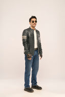 Man wearing navy blue designer leather Biker Jacket with quilted shoulder pads and multiple zipper pockets 