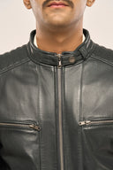 Close-up of man wearing navy blue leather biker jacket with focus on zipper pockets, front zipper and snap buttons