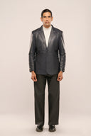 Man wearing navy blue genuine leather blazer, notch collar, horn buttons, patch pockets, paired with black pants