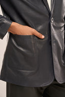 Close-up of man wearing leather blazer for men, navy blue, detail shot of horn buttons, full sleeves, and patch pockets