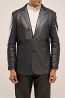 Man wearing leather blazer for men, navy blue, regular fit, horn buttons, and patch pockets, paired with black pants