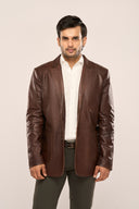Man wearing leather blazer for men, coffee brown, regular fit, horn buttons, patch pockets, paired with dark brown trousers