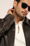 Man wearing black leather jacket, close-up of front zip closure, structured collar, sleeve zip detail