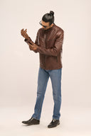 Man wearing coffee brown leather Biker Jacket with front zip is closing the snap buttons cuffs for adjustable fit and comfort