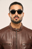 Close-up of man wearing coffee brown leather biker jacket with focus on zipper pockets, front zipper and snap buttons
