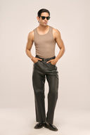 Man posing while wearing beige vest with a pair of supple & lightweight goat Nappa leather trousers made for everyday wear