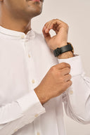 Close-up of man wearing white shirt for men with mandarin collar, button-down front, full sleeves and buttoned-cuff.