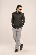 Model in charcoal black pleat shirt showcasing front pleats and modern slim-fit silhouette, worn with grey trousers.