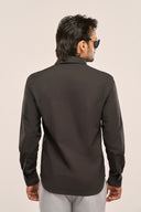Back view of man in charcoal black shirt for men with full sleeves, paired with grey trousers and sunglasses.