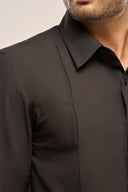 Close up of man wearing charcoal black shirt for men with unique pleat detail.