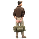 Model Carrying Dark Olive Trailblazer Leather Travel Duffle Bag.