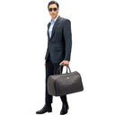 Model Carrying Monarch Premium Leather Travel Duffle Bag. 