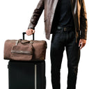 Model Carrying The Brown Trailblazer Premium Leather Duffle Bag. 