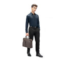 Model Carrying The Coffee Hercules Premium Leather Briefcase. 